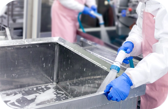 Factory workers cleaning utensils using Sanistar Water
